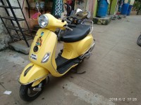 Yellow Vespa VX 125