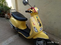 Yellow Vespa VX 125