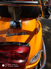 Orange Vespa SXL 125