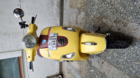Yellow Vespa VX 125