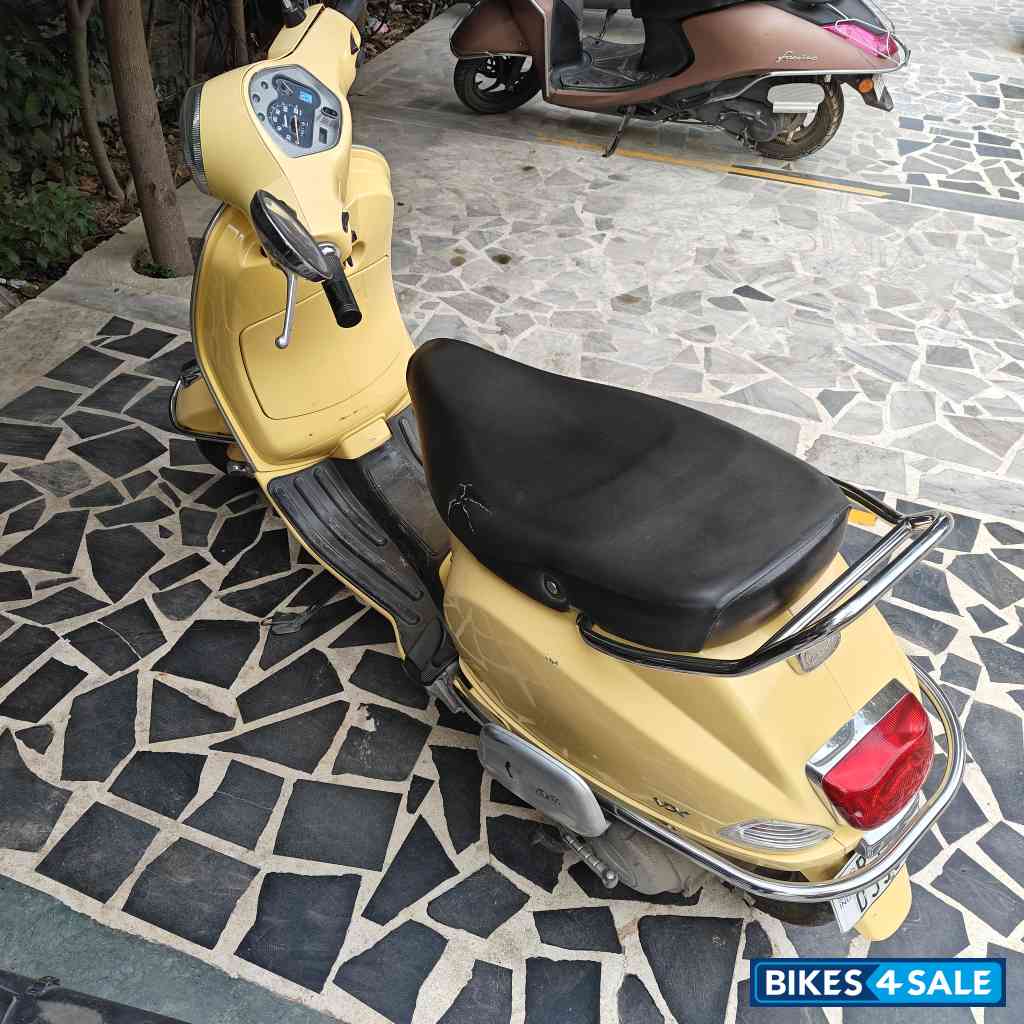 Yellow Vespa VX 125