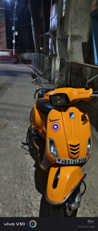 Orange Vespa SXL 150
