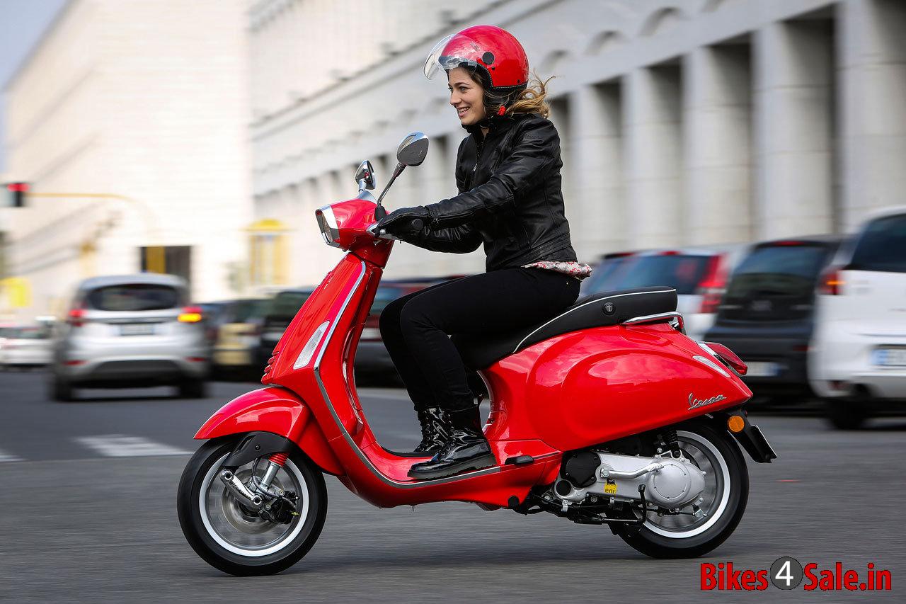 Vespa Sprint 125 - Picture showing a lady riding Red colored Vespa Sprint 125
